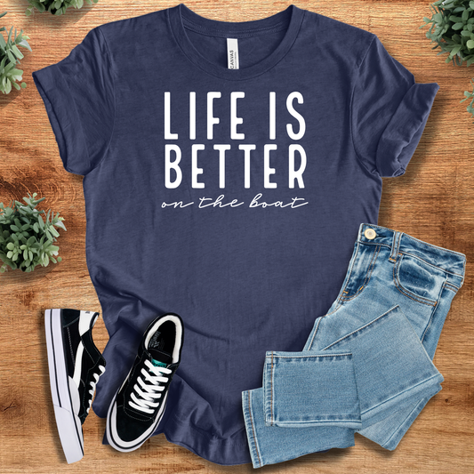 Navy blue 'Life is Better on the Boat' boating t-shirt styled with jeans and sneakers. Ideal nautical graphic top for summer boat outings.