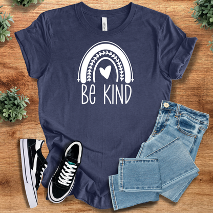 Heather-mauve t-shirt with '' text, flat lay styled on a wooden surface.