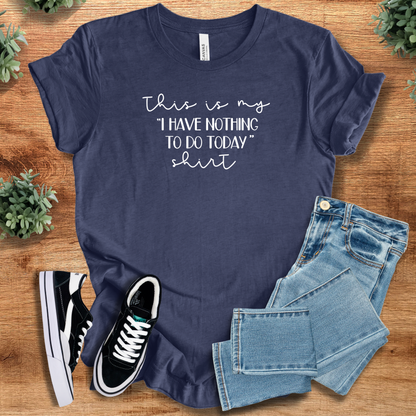 Yellow t-shirt with '' text, flat lay styled on a wooden surface.