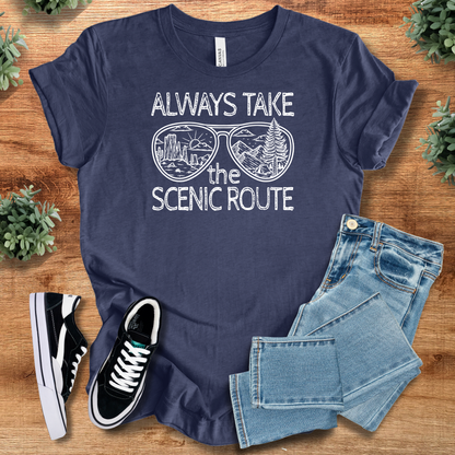 Heather-mauve t-shirt with '' text, flat lay styled on a wooden surface.
