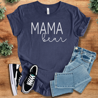 Heather-navy t-shirt with 'Mama Bear T‑Shirt' text, flat lay styled on a wooden surface.