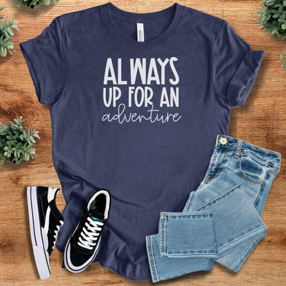 Heather-mauve t-shirt with '' text, flat lay styled on a wooden surface.