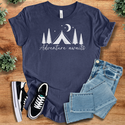 Military-green t-shirt with '' text, flat lay styled on a wooden surface.