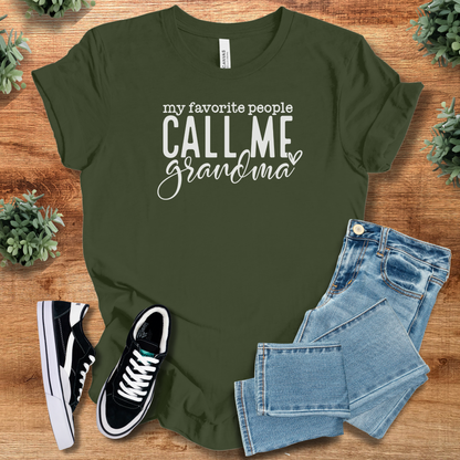 Heather-navy t-shirt with '' text, flat lay styled on a wooden surface.