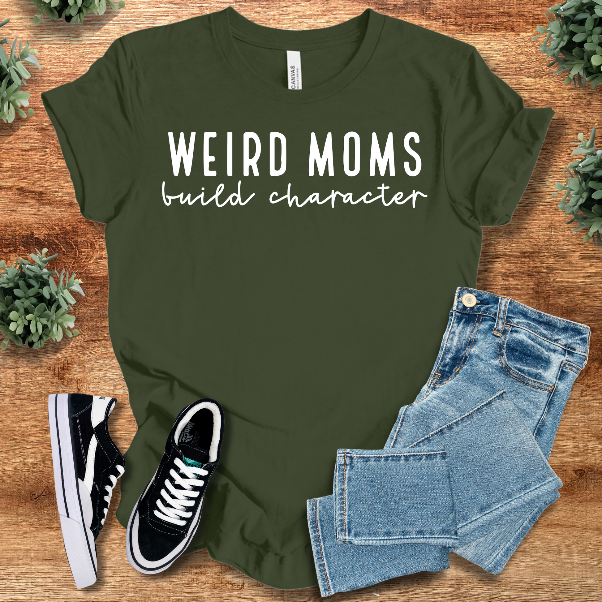 Heather-mauve t-shirt with '' text, flat lay styled on a wooden surface.