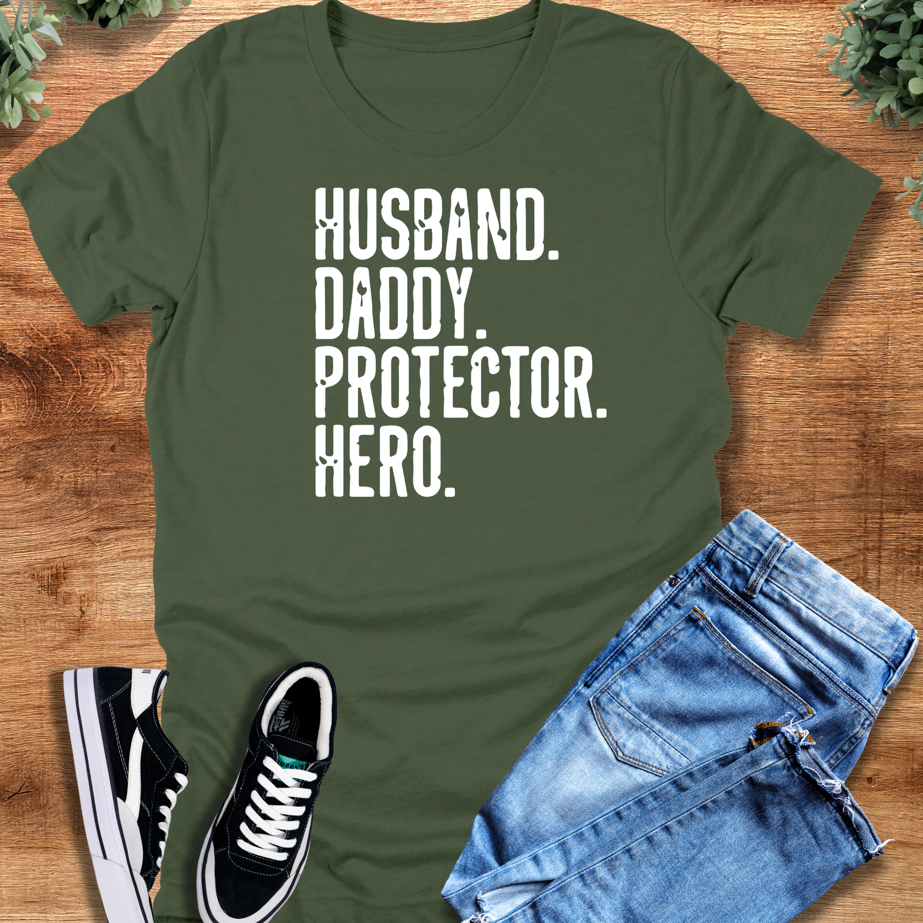 Heather-navy t-shirt with '' text, flat lay styled on a wooden surface.