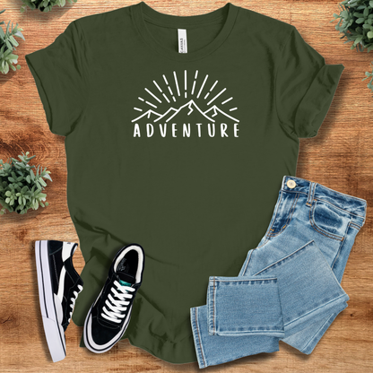 Pink t-shirt with '' text, flat lay styled on a wooden surface.