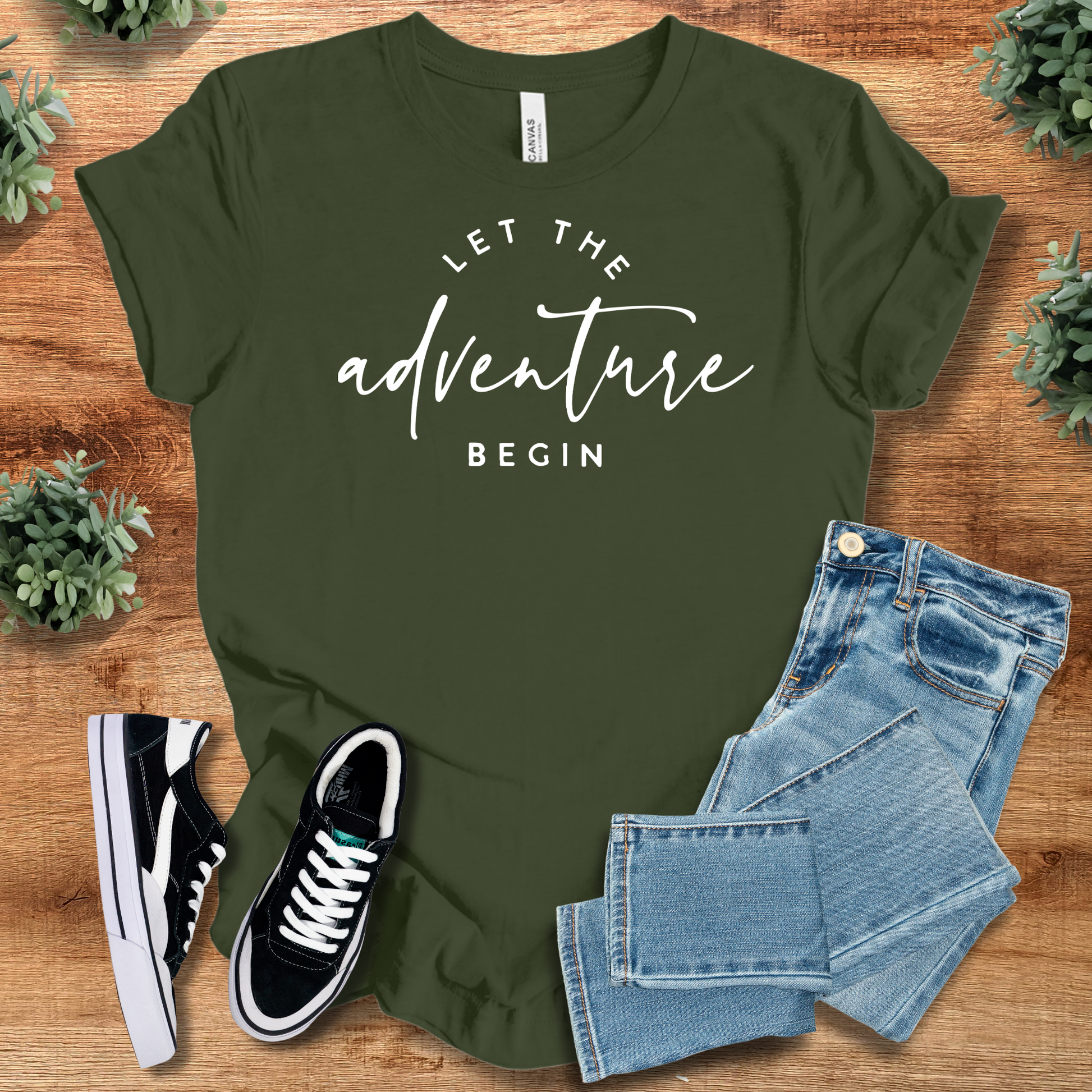 Heather-aqua t-shirt with '' text, flat lay styled on a wooden surface.