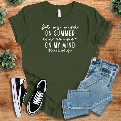 Heather-aqua t-shirt with '' text, flat lay styled on a wooden surface.