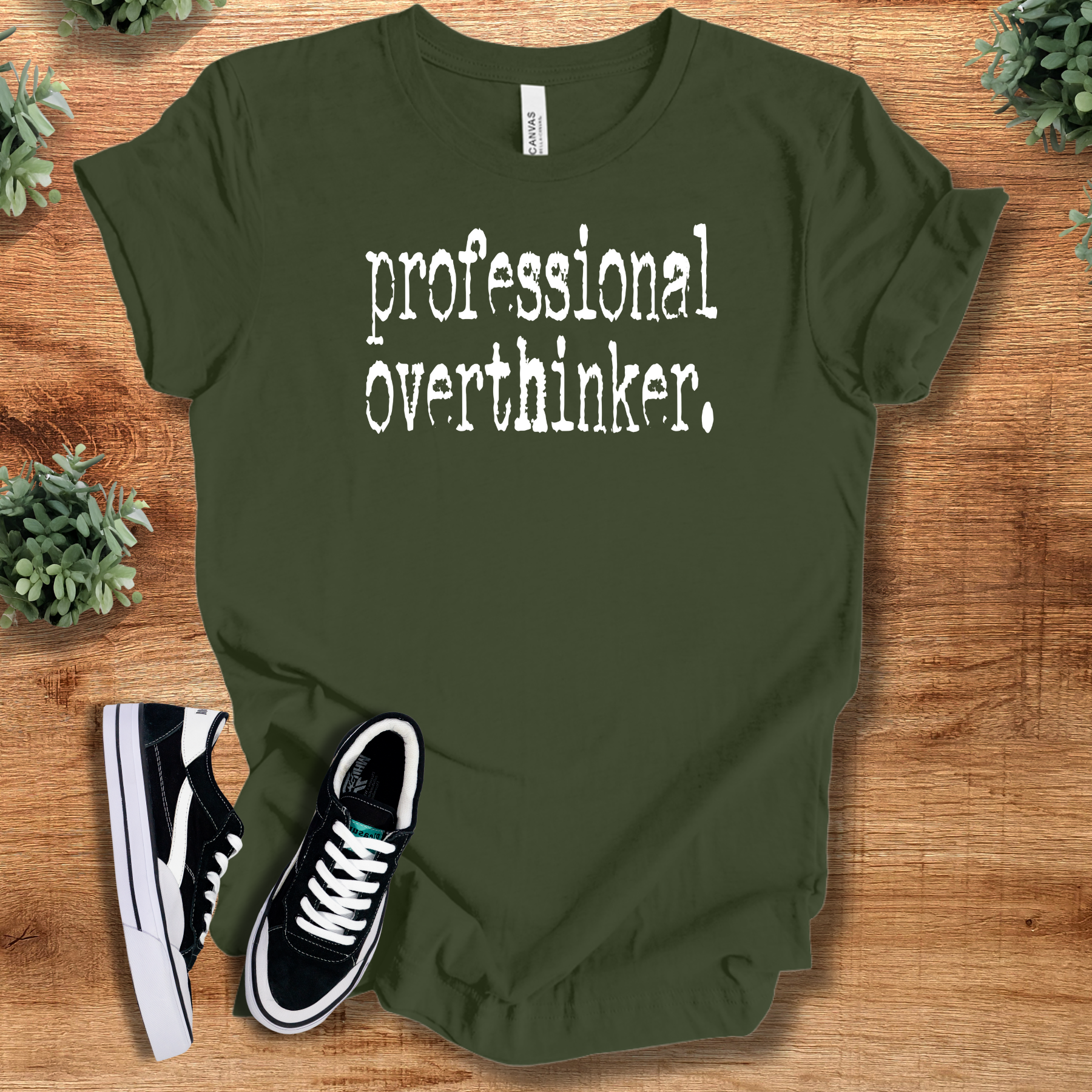Heather-aqua t-shirt with '' text, flat lay styled on a wooden surface.