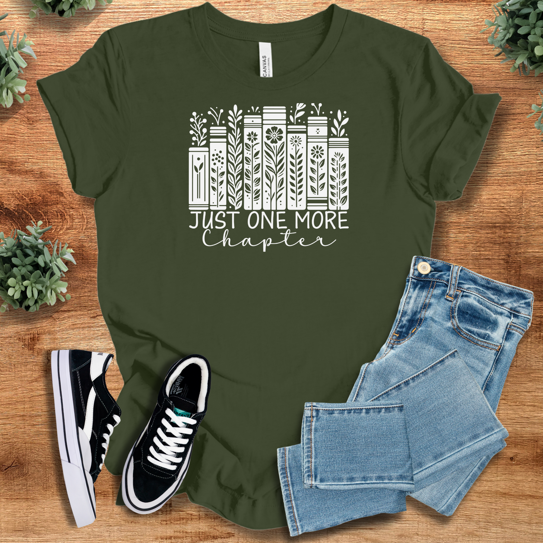 Heather-mauve t-shirt with '' text, flat lay styled on a wooden surface.