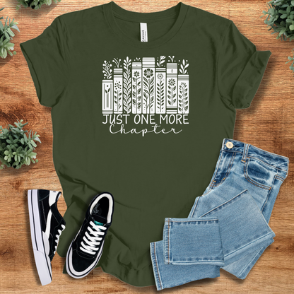 Heather-mauve t-shirt with '' text, flat lay styled on a wooden surface.