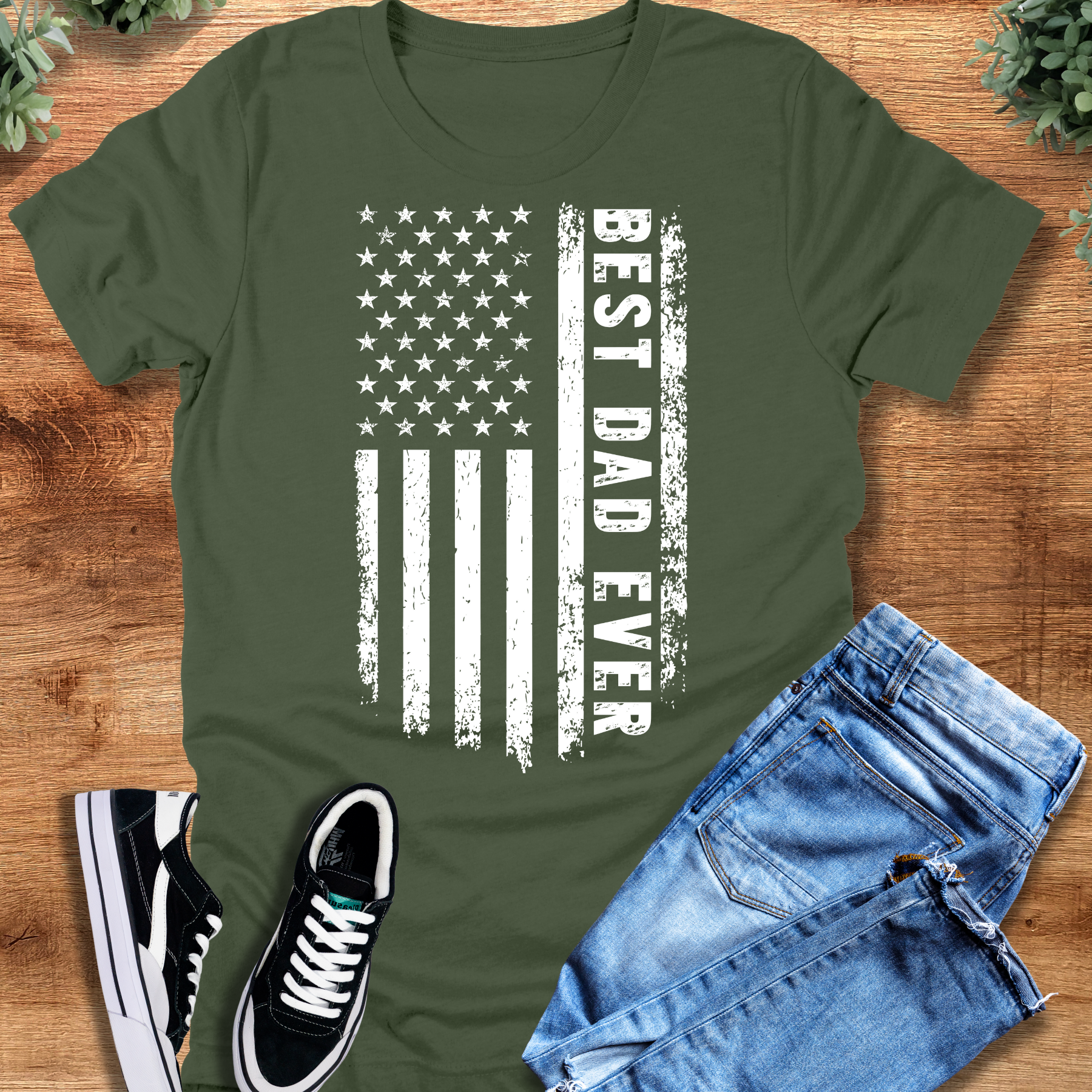 Black t-shirt with '' text, flat lay styled on a wooden surface.