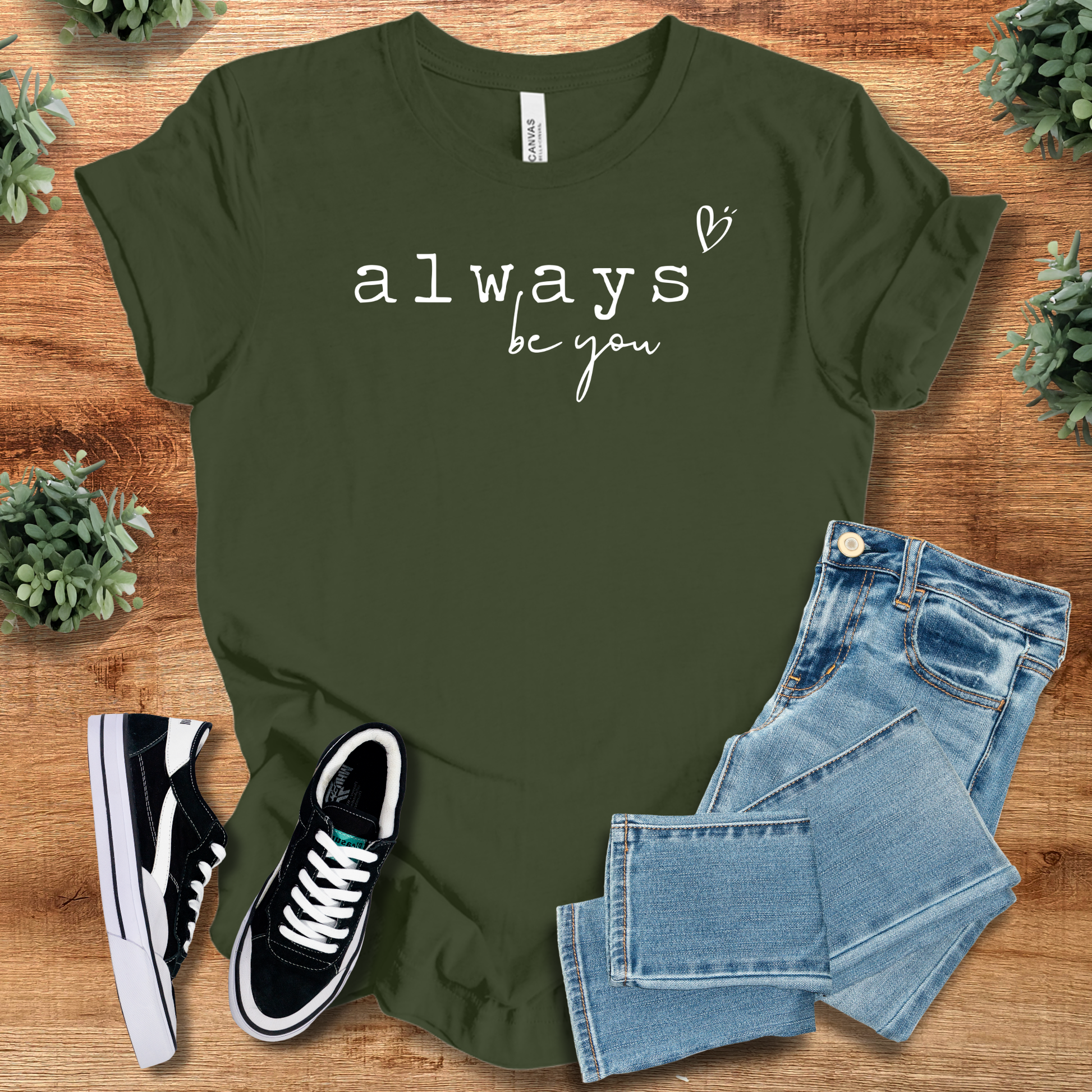Heather-aqua t-shirt with '' text, flat lay styled on a wooden surface.