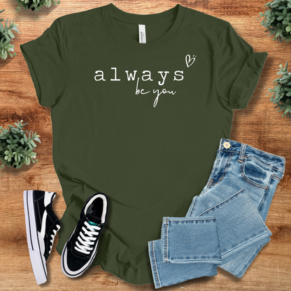Heather-aqua t-shirt with '' text, flat lay styled on a wooden surface.