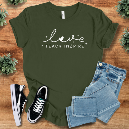 Heather-mauve t-shirt with '' text, flat lay styled on a wooden surface.