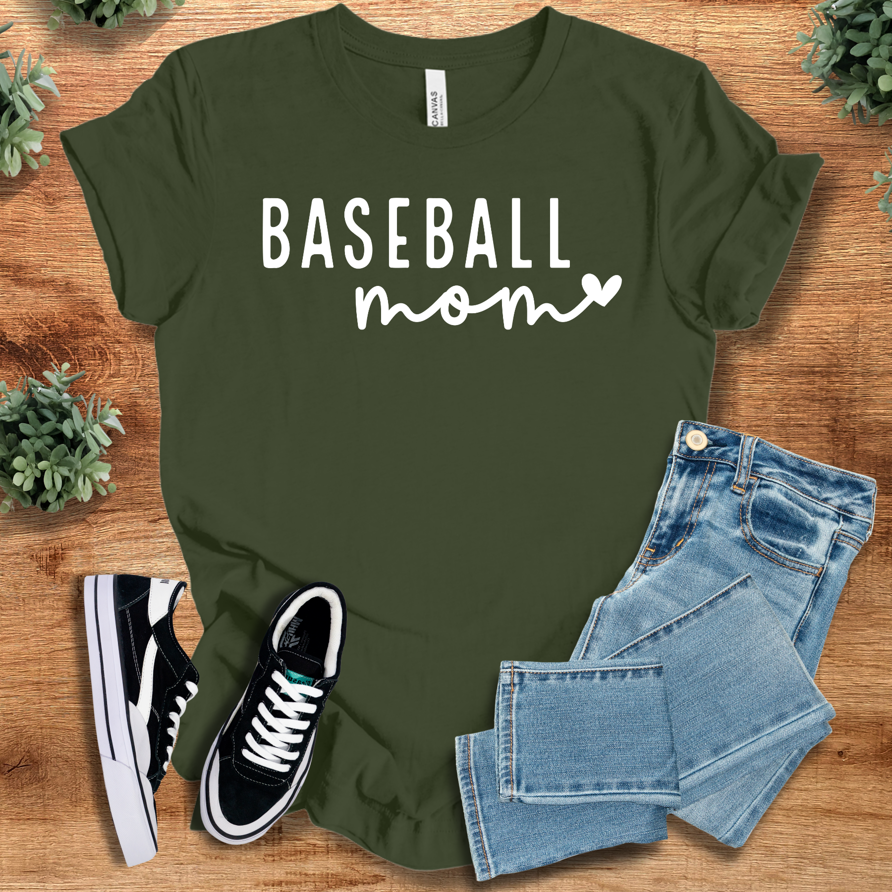 Heather-navy t-shirt with '' text, flat lay styled on a wooden surface.