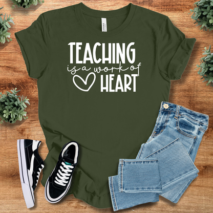 Heather-aqua t-shirt with '' text, flat lay styled on a wooden surface.