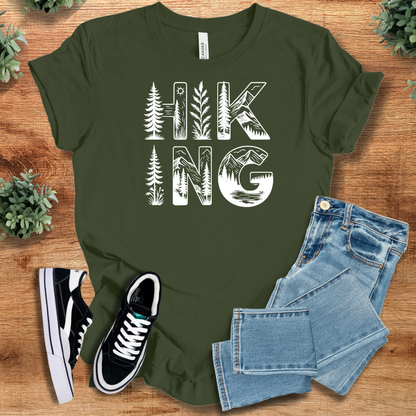 Pink t-shirt with '' text, flat lay styled on a wooden surface.
