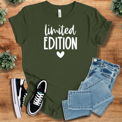 Heather-aqua t-shirt with '' text, flat lay styled on a wooden surface.