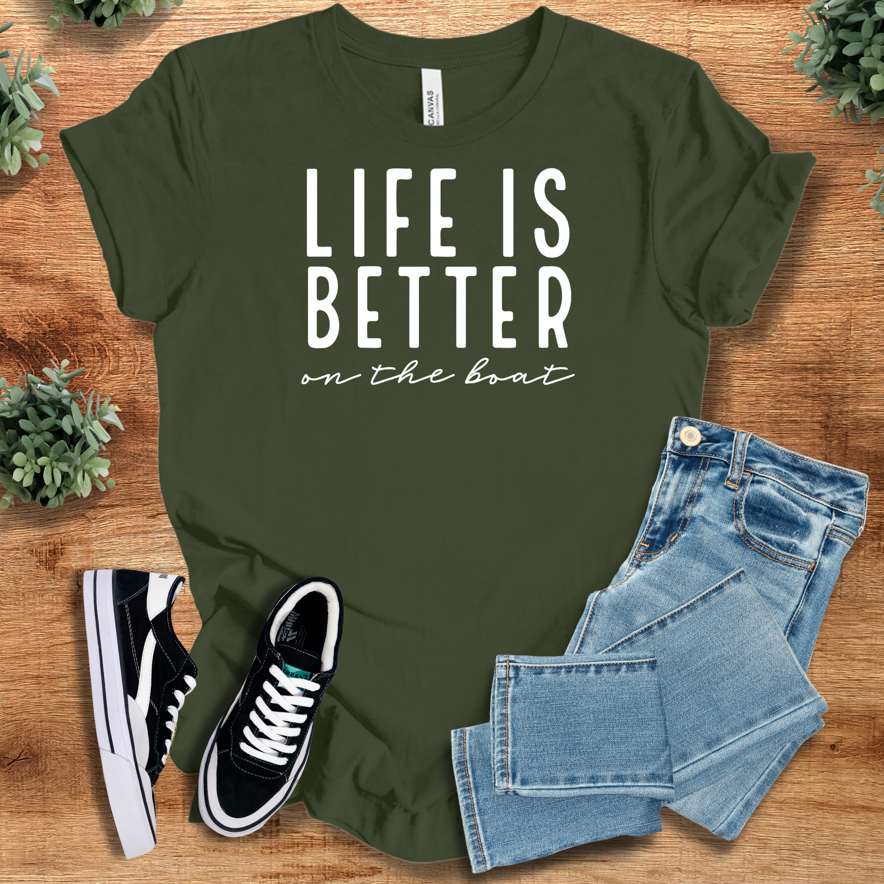 Heather-navy t-shirt with '' text, flat lay styled on a wooden surface.