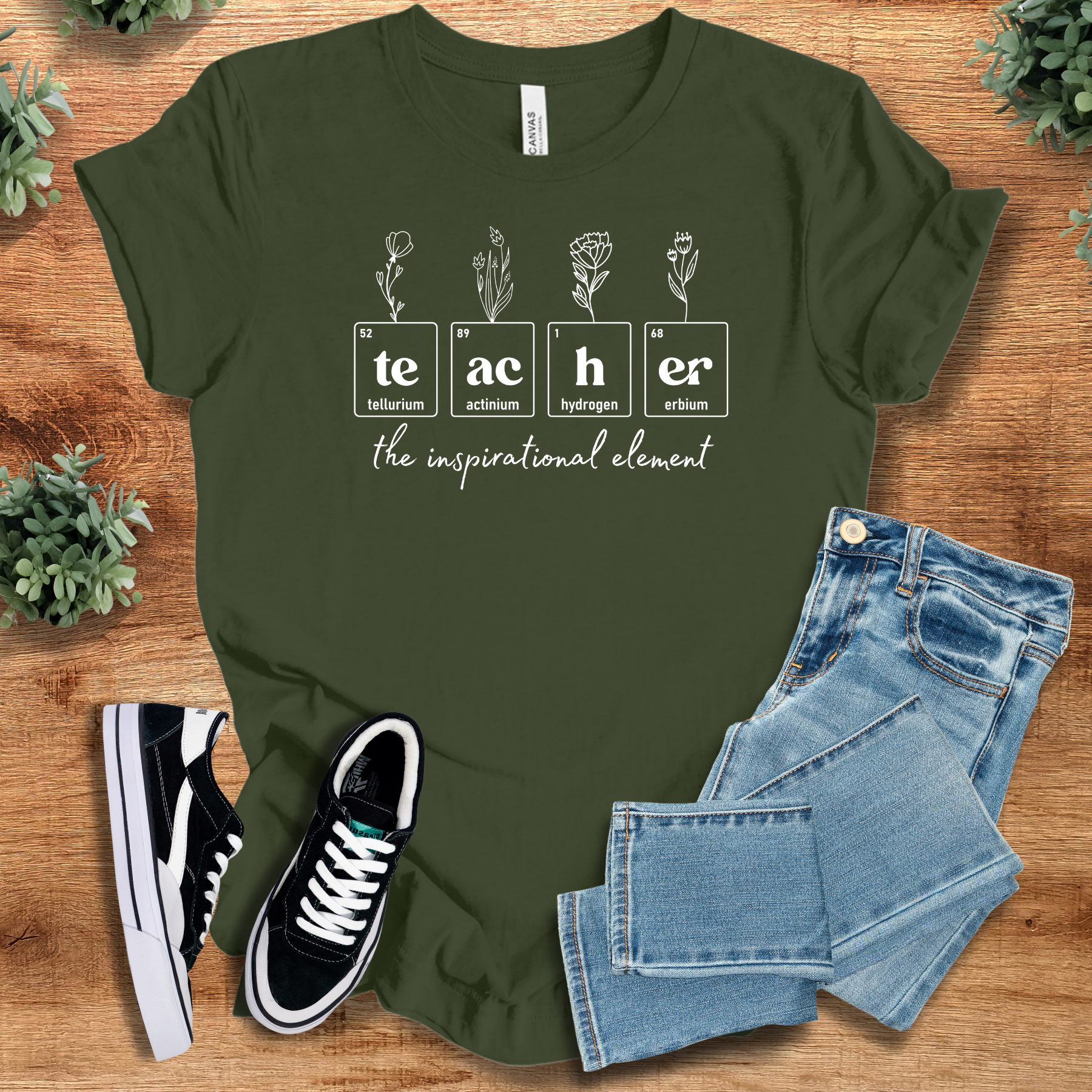 Heather-mauve t-shirt with '' text, flat lay styled on a wooden surface.