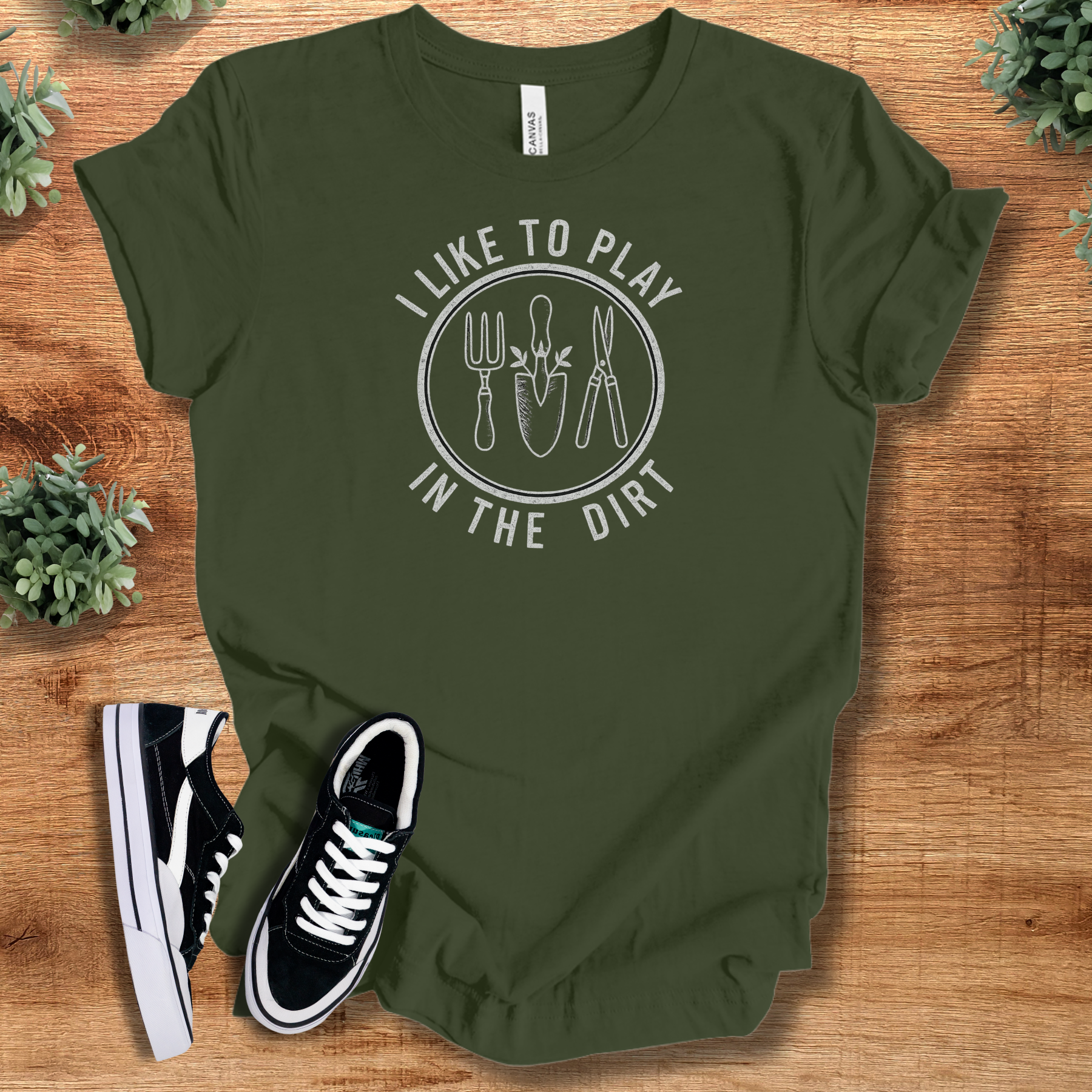 Heather-mauve t-shirt with '' text, flat lay styled on a wooden surface.