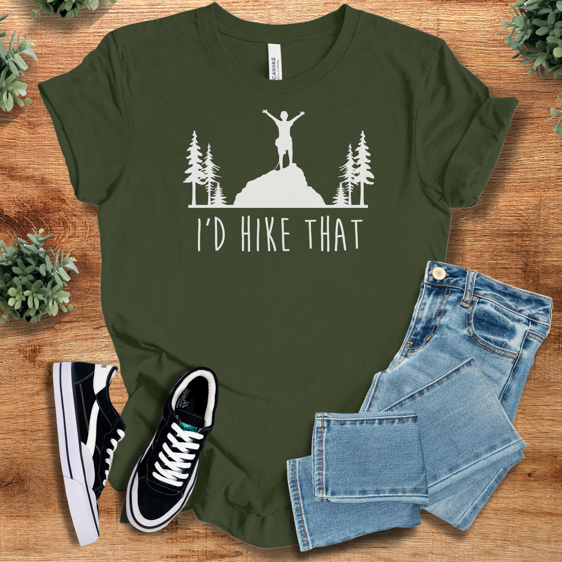 Heather-mauve t-shirt with '' text, flat lay styled on a wooden surface.