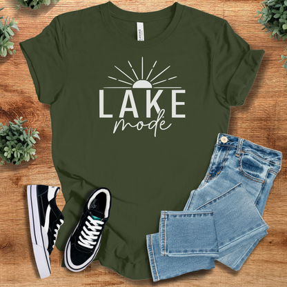 Heather-mauve t-shirt with '' text, flat lay styled on a wooden surface.