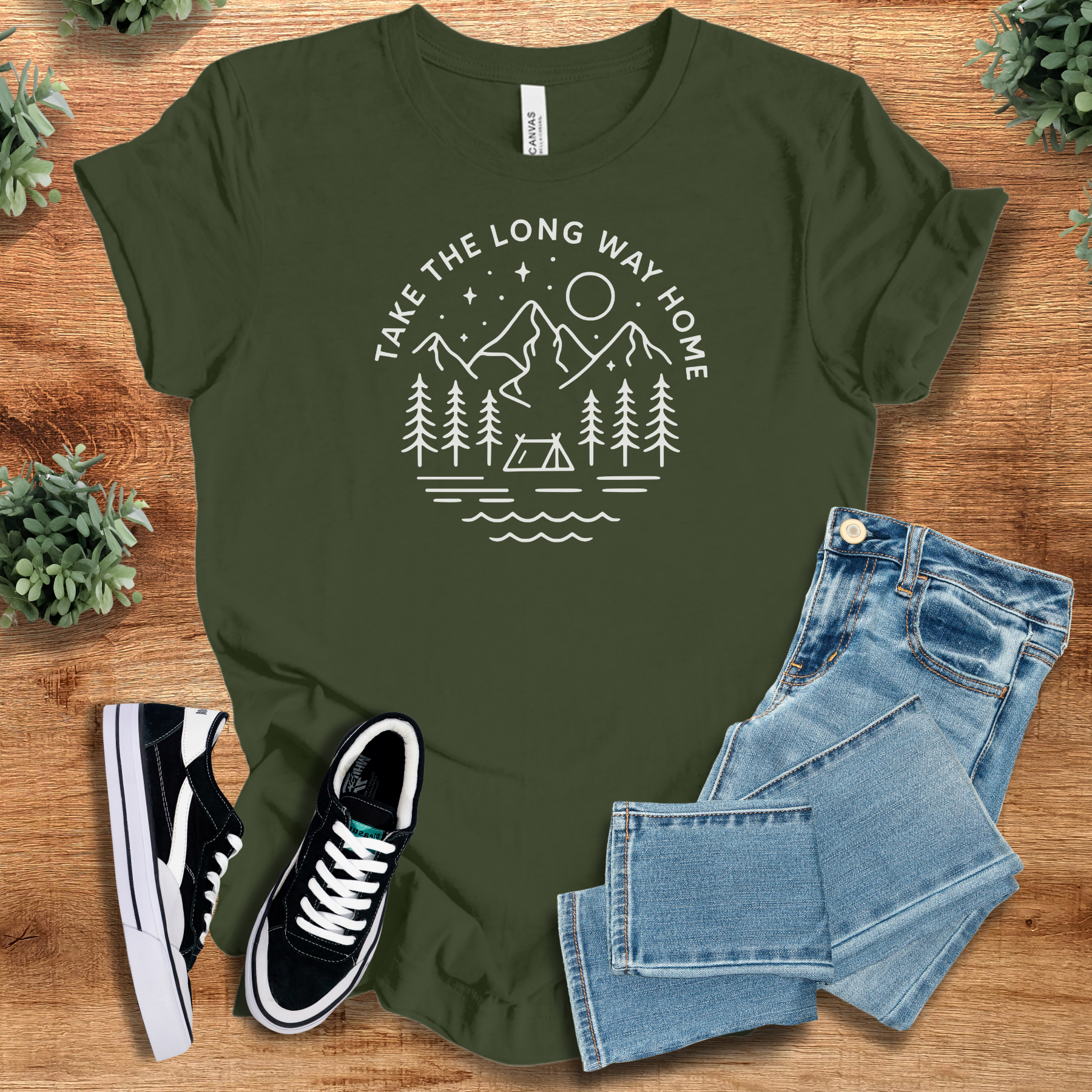 Heather-aqua t-shirt with '' text, flat lay styled on a wooden surface.