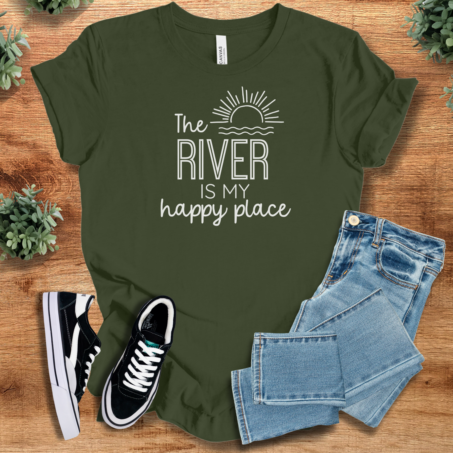 Heather-navy t-shirt with '' text, flat lay styled on a wooden surface.