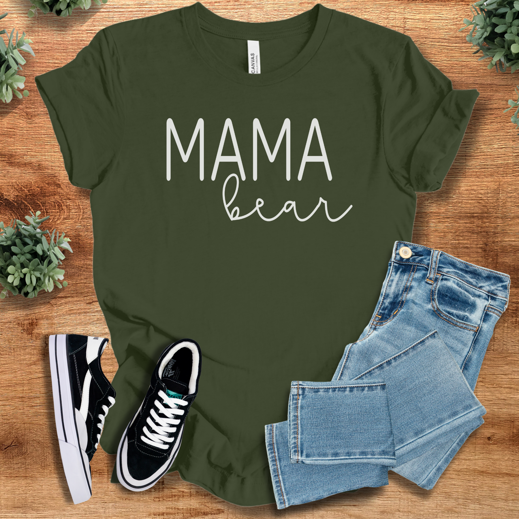 Heather-navy t-shirt with '' text, flat lay styled on a wooden surface.