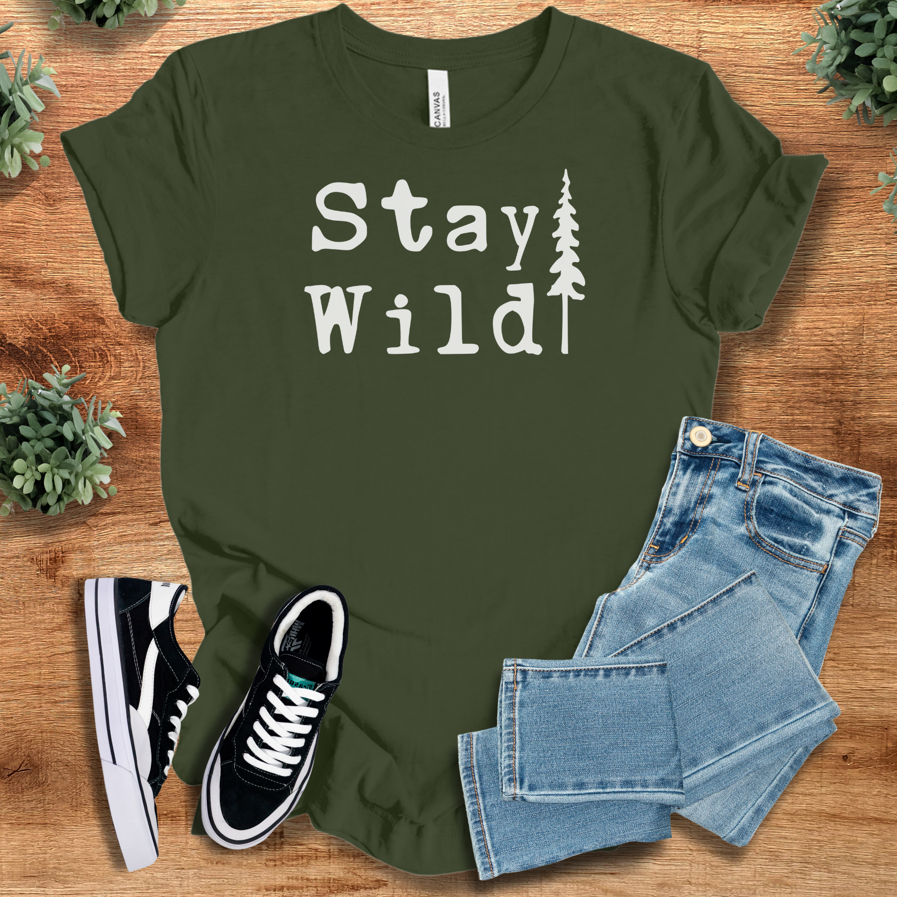 Heather-navy t-shirt with '' text, flat lay styled on a wooden surface.