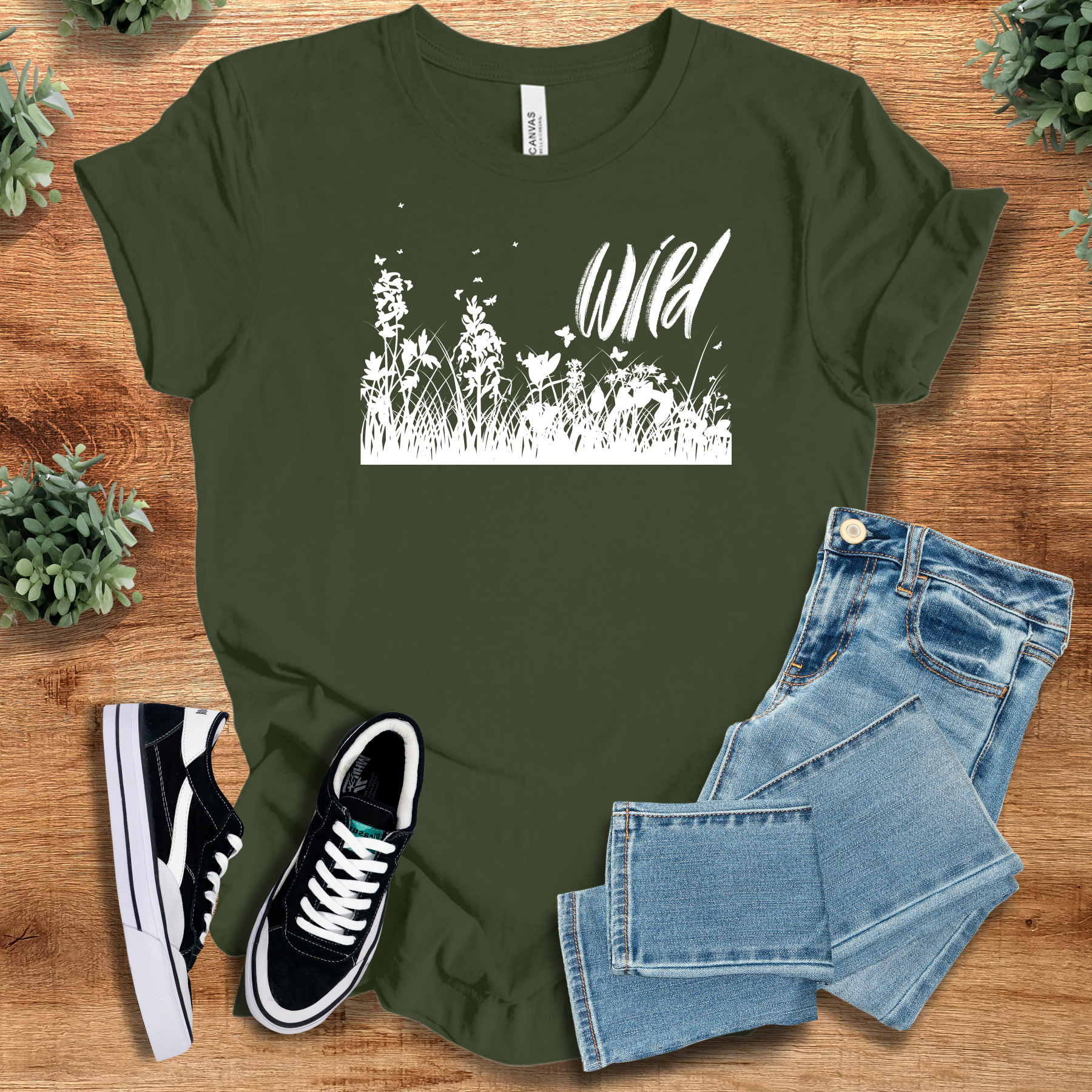 Heather-mauve t-shirt with '' text, flat lay styled on a wooden surface.