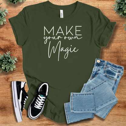 Pink t-shirt with '' text, flat lay styled on a wooden surface.