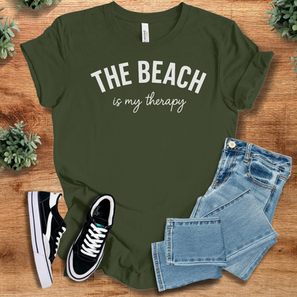 Heather-aqua t-shirt with '' text, flat lay styled on a wooden surface.