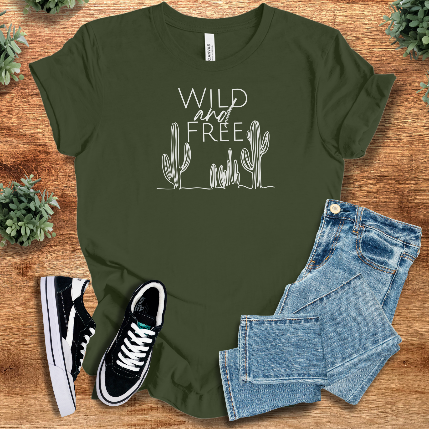 Heather-navy t-shirt with '' text, flat lay styled on a wooden surface.
