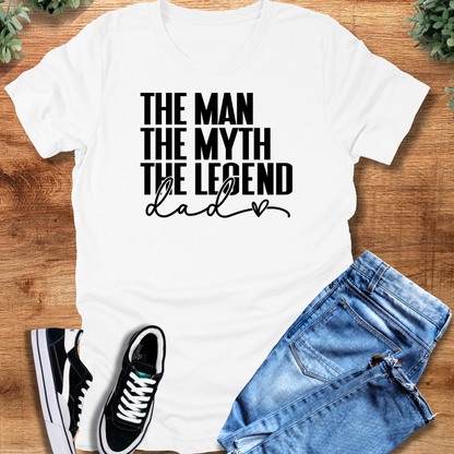 Black t-shirt with '' text, flat lay styled on a wooden surface.