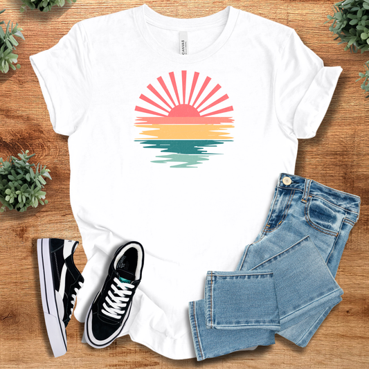 Vibrant Sunset T-Shirt in white featuring a colorful sunset graphic with pink, orange, and teal tones. Lightweight cotton tee ideal for summer wear.