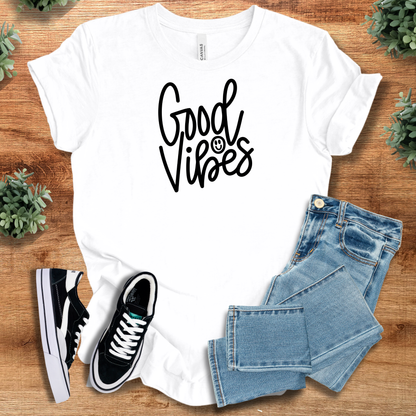 Heather-aqua t-shirt with '' text, flat lay styled on a wooden surface.