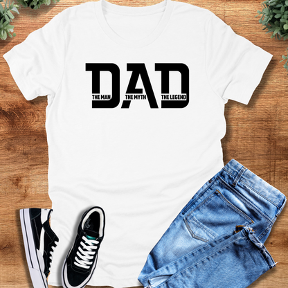 Military-green t-shirt with '' text, flat lay styled on a wooden surface.