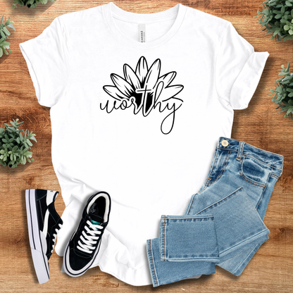 Heather-aqua t-shirt with '' text, flat lay styled on a wooden surface.