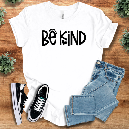 Heather-mauve t-shirt with '' text, flat lay styled on a wooden surface.