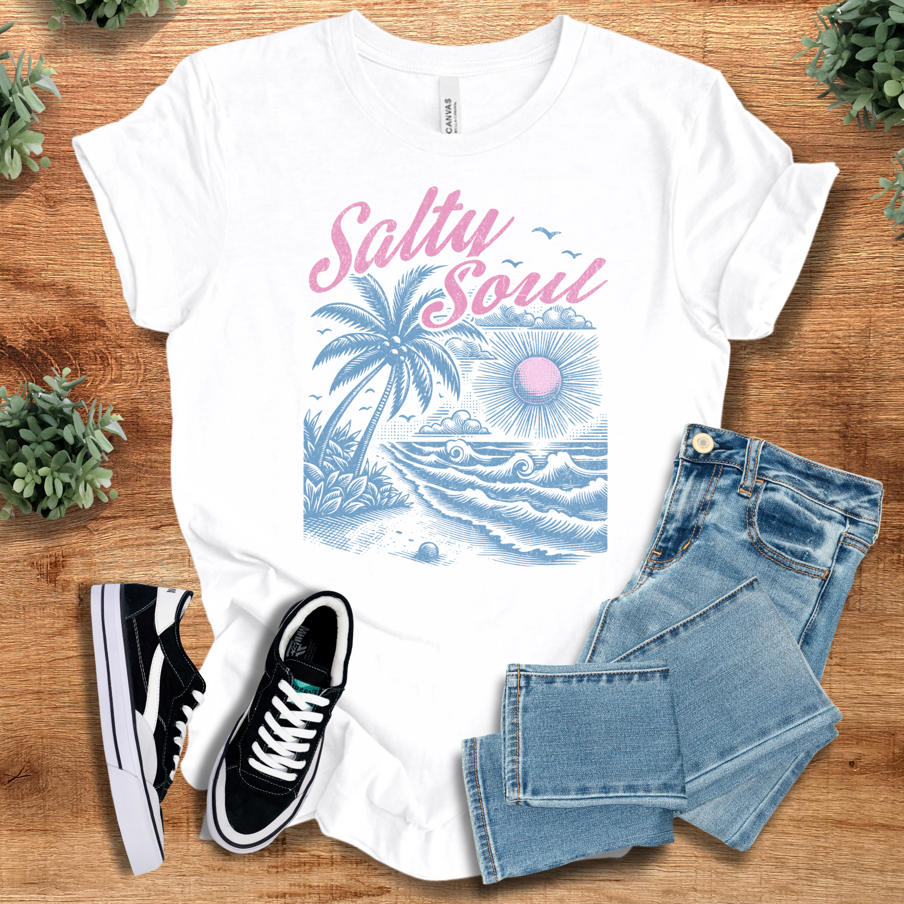 Heather-navy t-shirt with '' text, flat lay styled on a wooden surface.