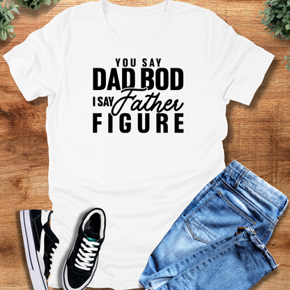 Military-green t-shirt with '' text, flat lay styled on a wooden surface.